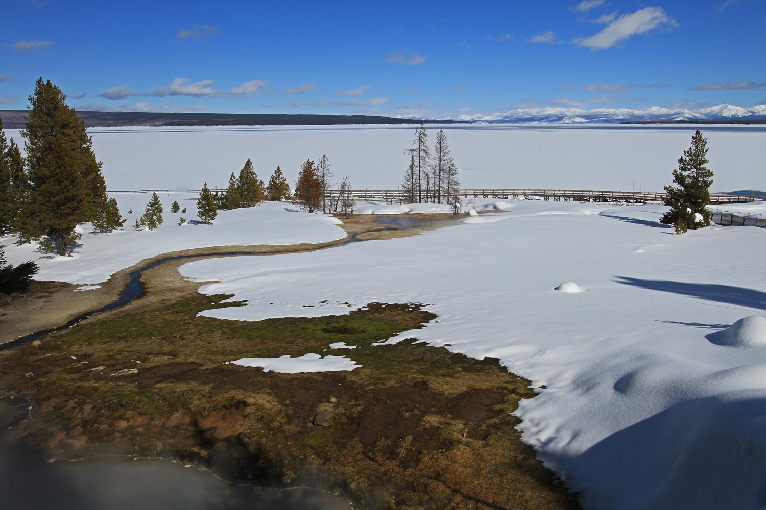 Yellowstone Lake seen past the blue water of Bluebell Pool at West Thumb.